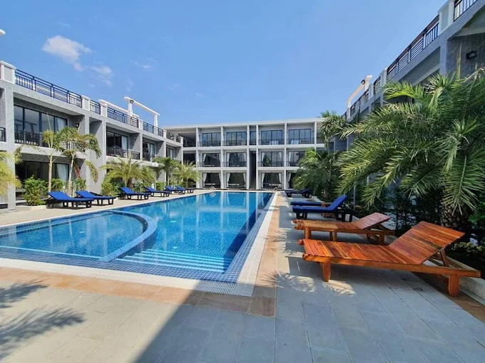 Pool with palm trees and sun loungers